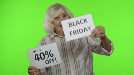 senior grandmother showing black friday, 40 percent off discount advertisement inscriptions