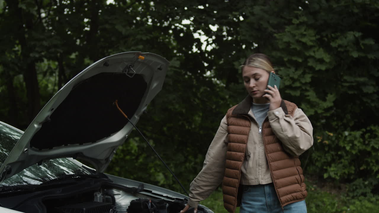 Woman calling for help with a broken down car