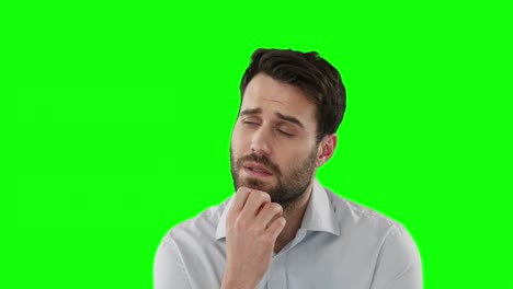 Thoughtful-man-standing-against-green-screen