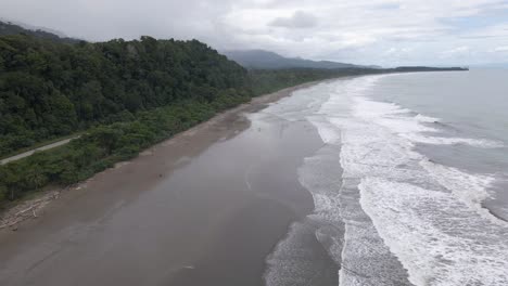 beautiful cinematic drone shot flying over playa hermosa beach in costa rica