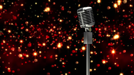 retro metallic microphone against red spots of light against black background