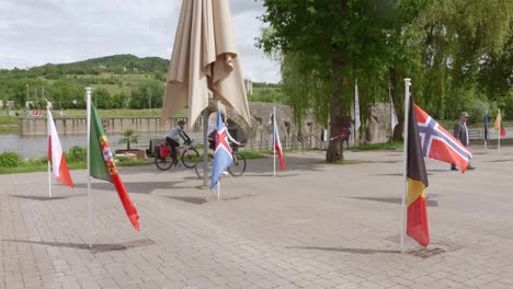 flags from various nations on display in schengen, luxembourg near the river and town square