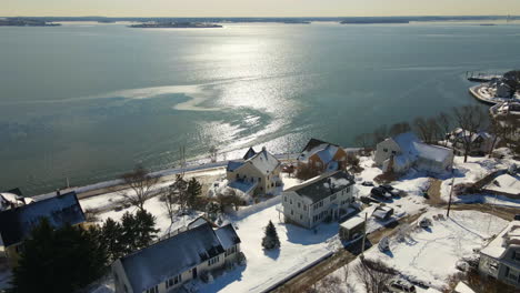 Aerial-footage-of-crossing-over-houses-to-the-water-in-Hull,-MA