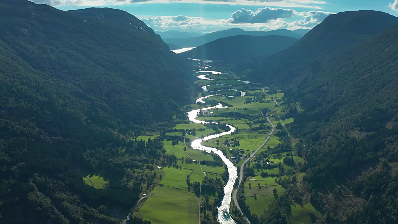 Flight over the Stryneelva river with its' many turns winds through the lush green Strynedalen valley in Norway