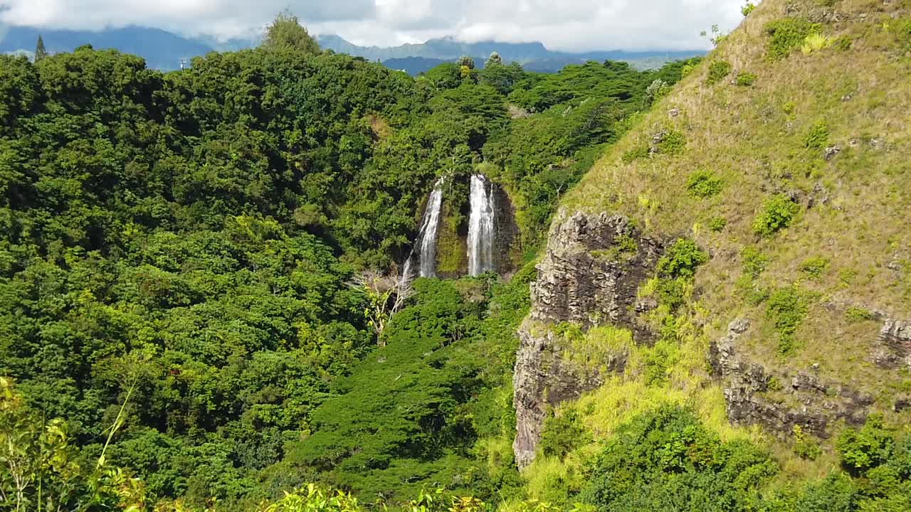 HD Slow motion Hawaii Kauai static 'Opaeka'a Falls with mostly cloudy sky