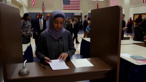 people voting at a polling place with american flags