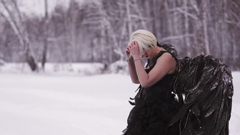 blonde woman plays phoenix character in winter forest