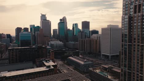 aerial drone shot of the minneapolis skyline backlit by the sun during golden hour