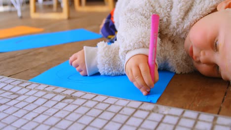 Girl-drawing-on-a-chart-paper-with-marker-4k