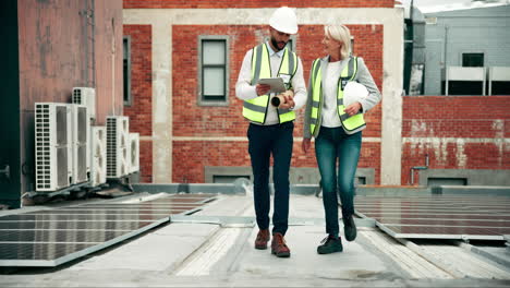 construction workers inspecting solar panels on a building