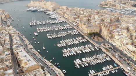 grand harbour marina view yatch port in the three cities, malta - fly-over aerial