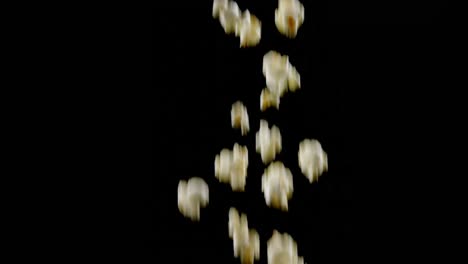 Popcorn-falling-against-black-background-4k