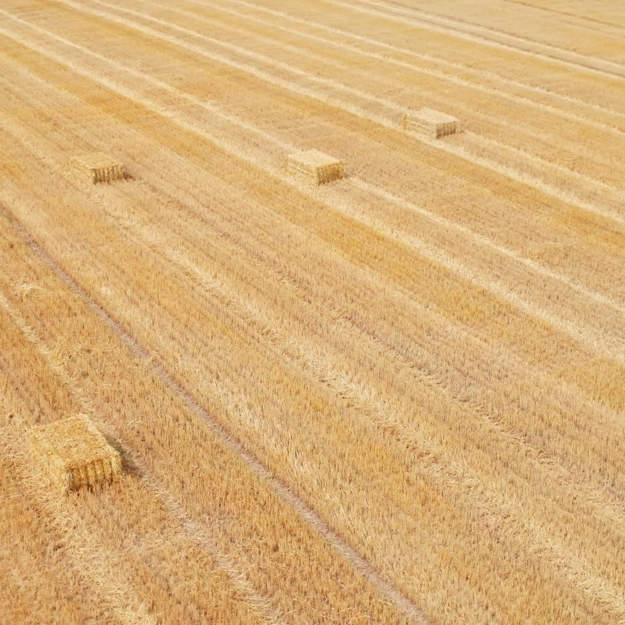 Hay bale in a shape of parallelepiped in the field. Circle movement over the straw pack with gradual rising