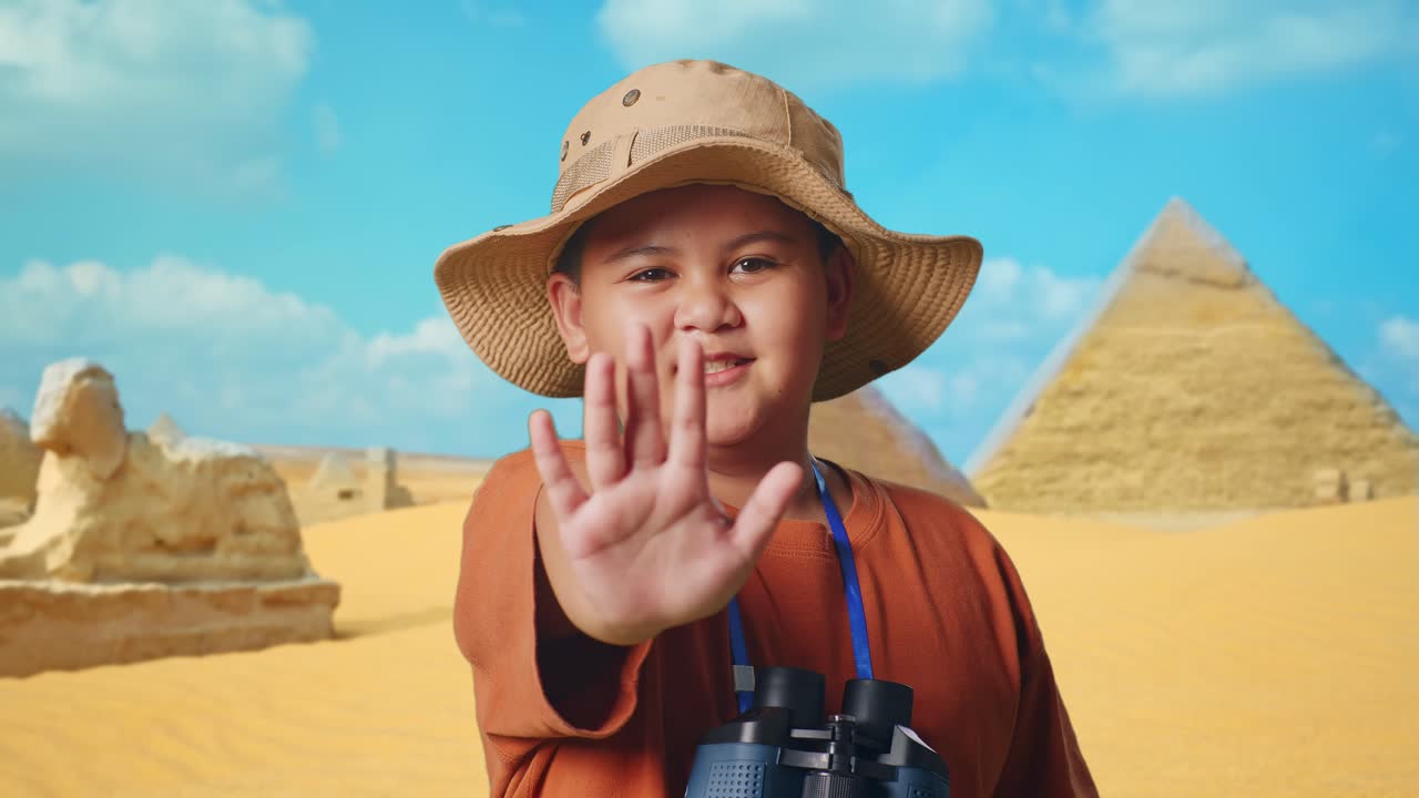 Asian Boy With A Hat And Binoculars Using The Magnifying Glass, Showing Hand No Gesture While Traveling In Giza Pyramid. Boy Researcher, Travel Tourism Adventure, Close Up