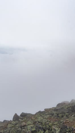 vertical 4k timelapse, clouds oh high elevation moving above valley and mountain peaks