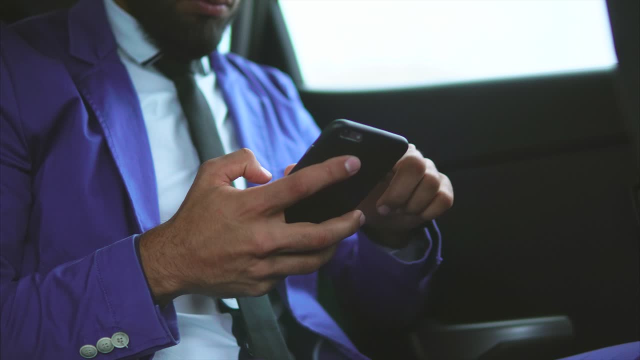 Businessman Texting in a Car