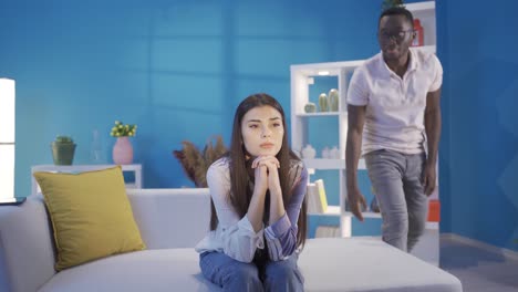 unhappy young woman is offended and angry at african young man with her boyfriend or wife.