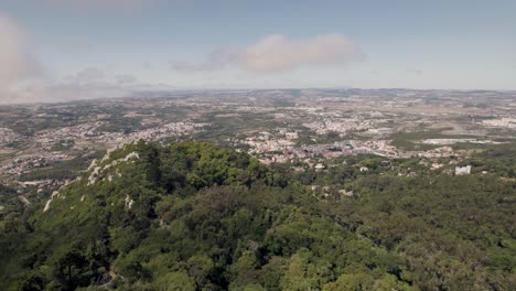 Panning-shot-capturing-hilltop-medieval-Castelo-dos-Mouros-and-beautiful-open-landscape-in-Sintra