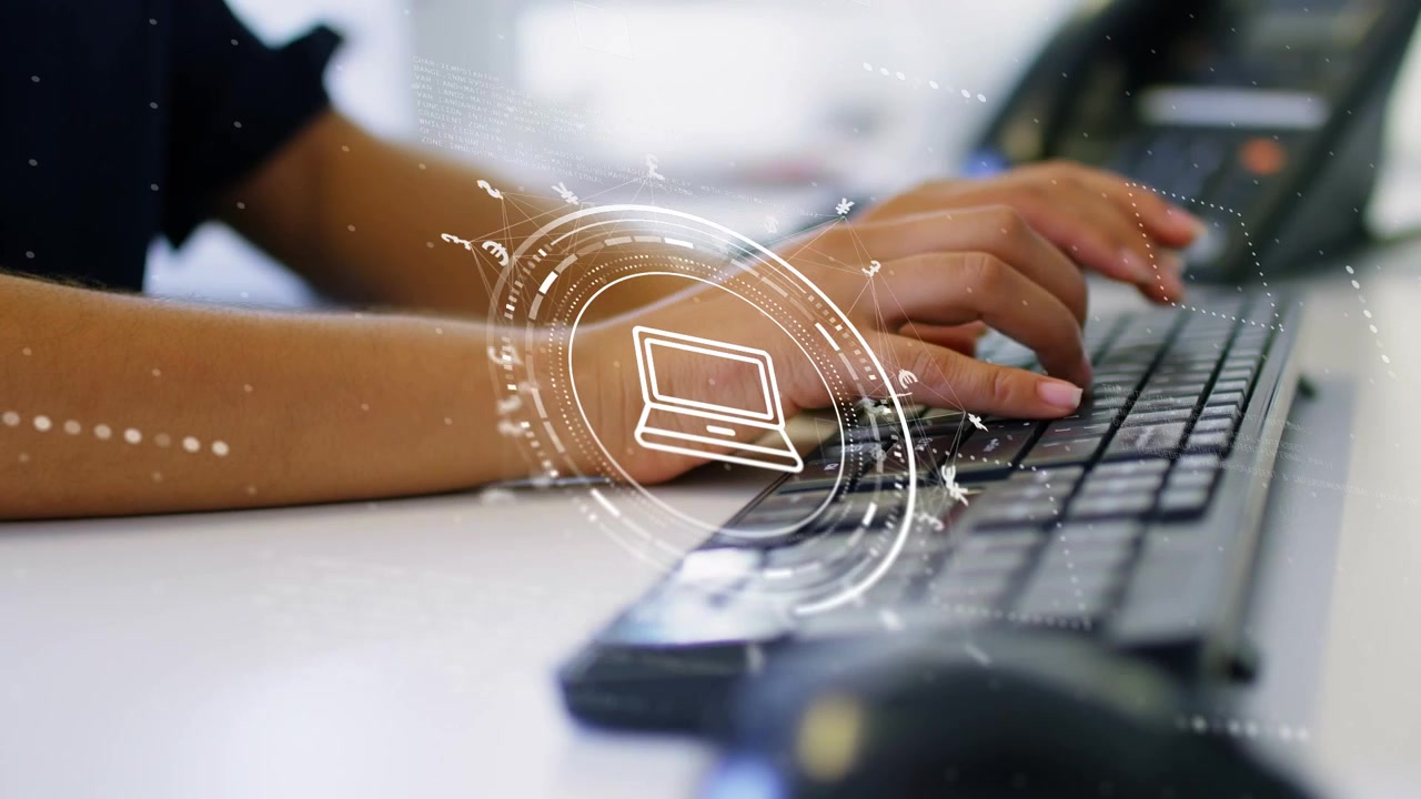 Woman typing on wired keyboard, keystrokes initiating rotating HUD laptop icon for data entry
