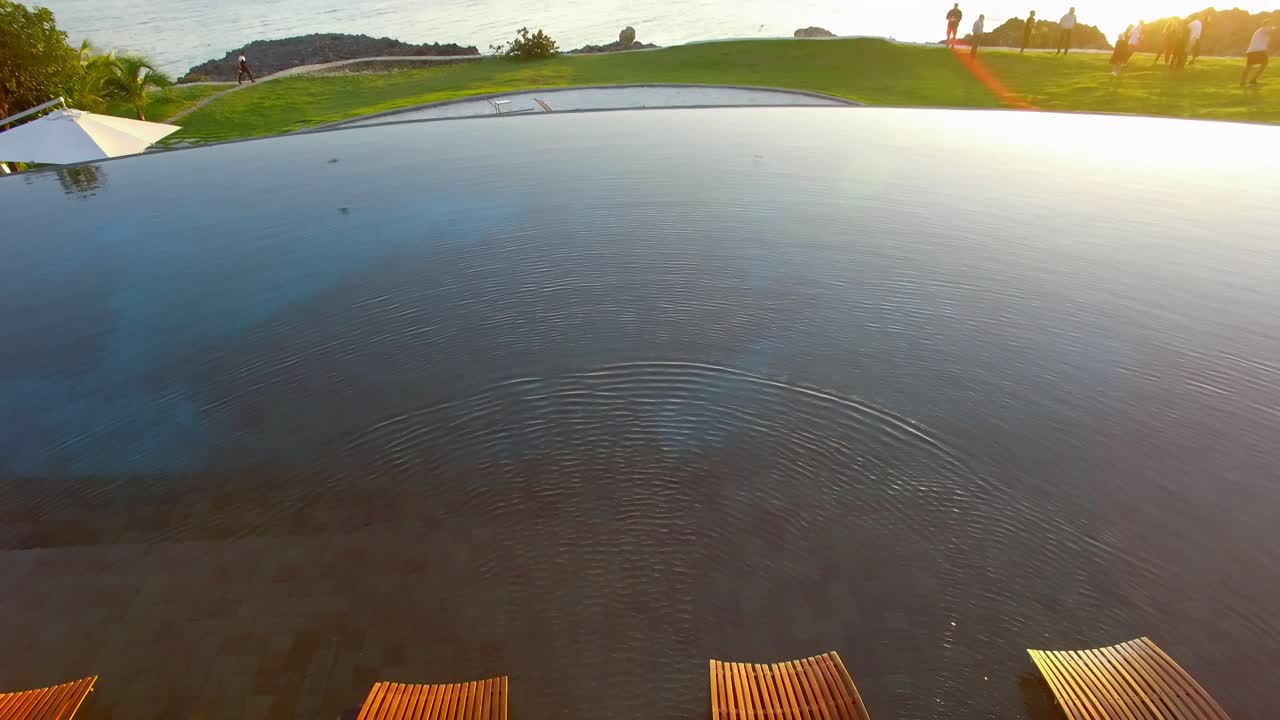 Tilt Up Scenic View over Resort Pool Sun Loungers to the Ocean, Dominican