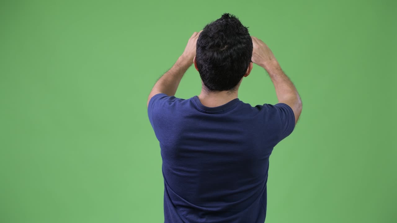 Rear view of Hispanic man photographing with phone