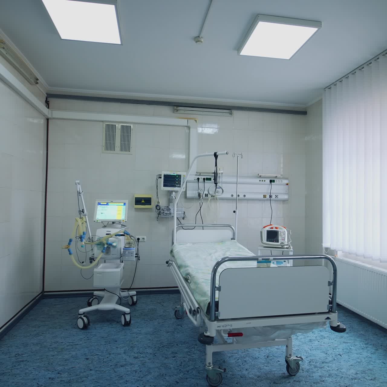 Modern ward of intensive care unit. Hospital room with bed and medical equipment in clinic. Interior of emergency room. Reanimation room