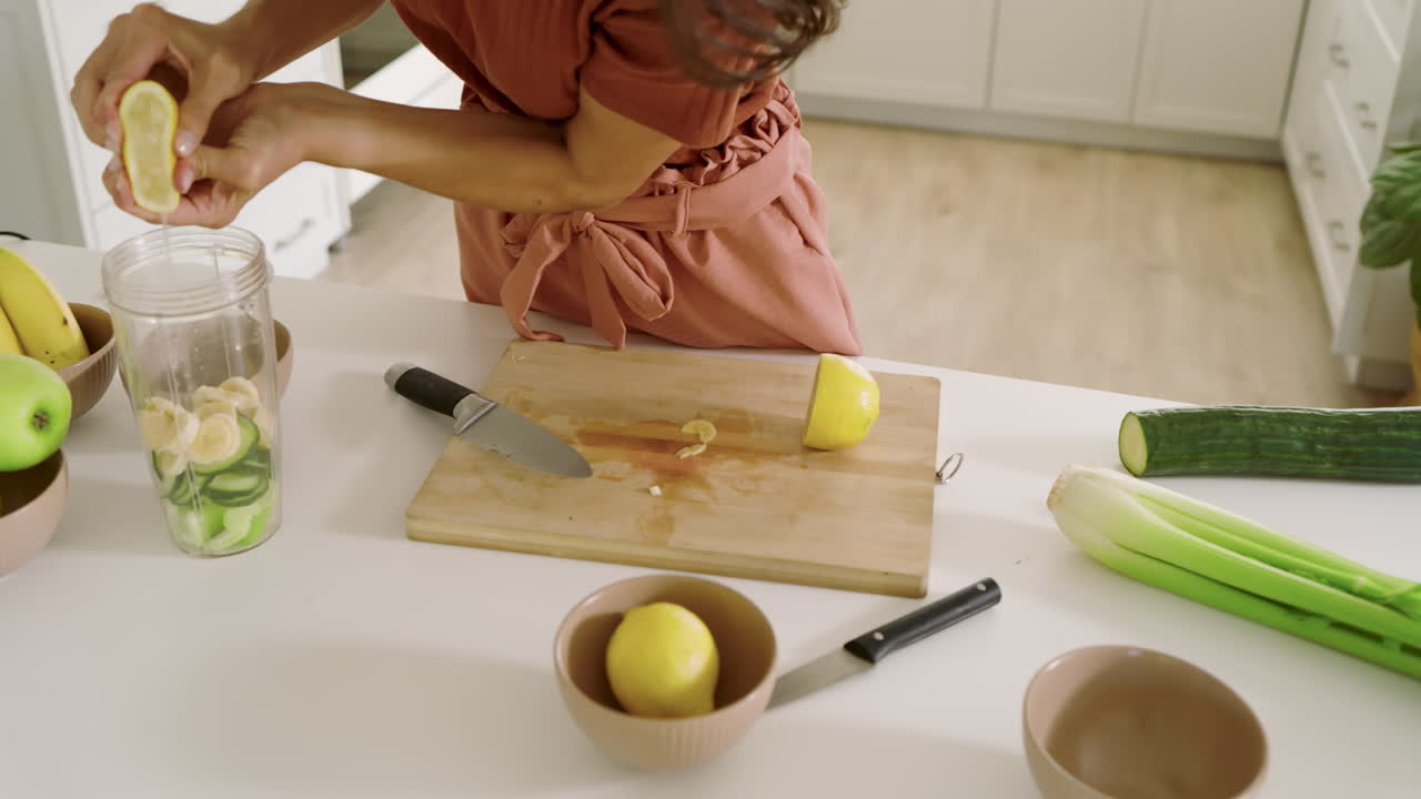 Woman preparing fresh vegetables in modern kitchen, focusing on healthy cooking