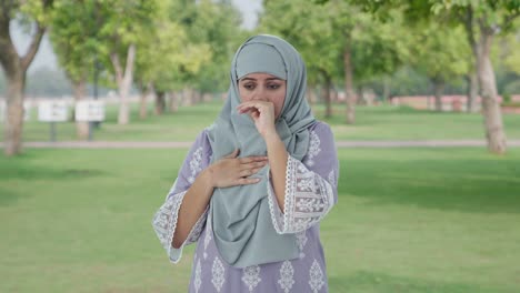 sick muslim woman suffering from fever in park