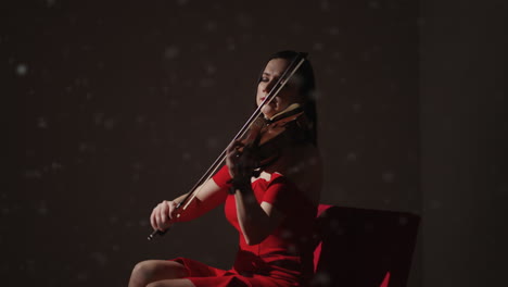 mujer tocando el violín en vestido rojo