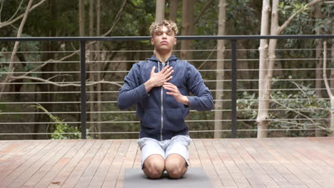 young man meditating outdoors on yoga mat, embracing tranquility and nature