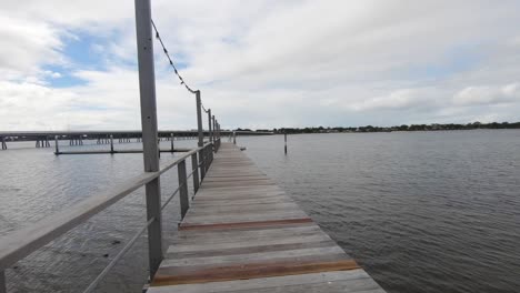 Walk-along-a-jetty-by-the-ocean-with-clouds-and-blue-sky