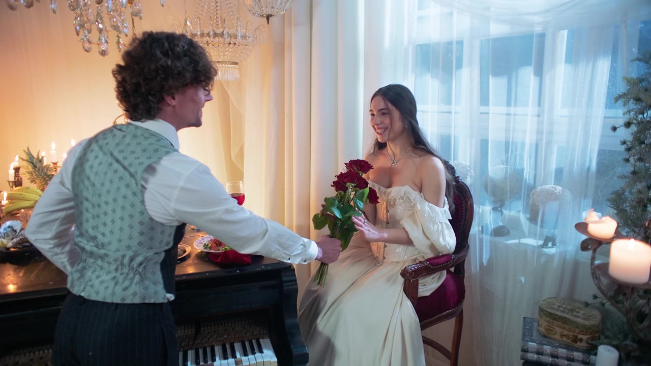 Man Presents Red Roses to Woman in Vintage Room
