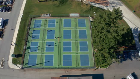 tennis players in a city park, drone truck left past the sports courts