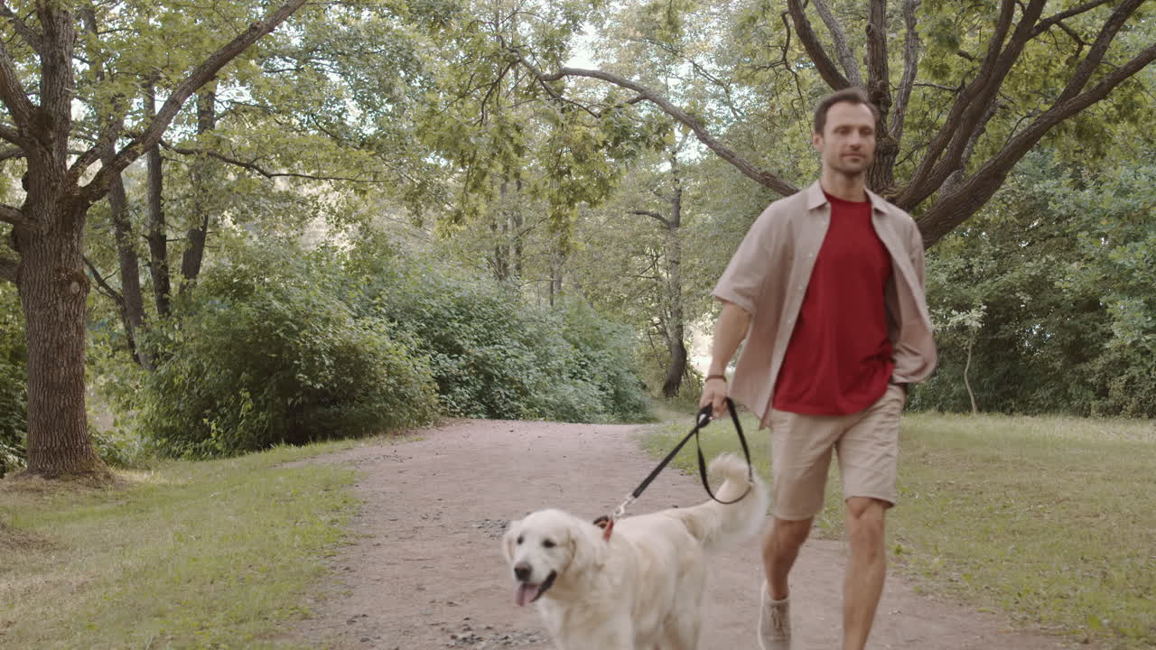 Man Walking Dog in Park