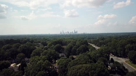 Aerial-view-of-Charlotte-NC-Skyline-in-the-distance-as-drone-pushes-forward