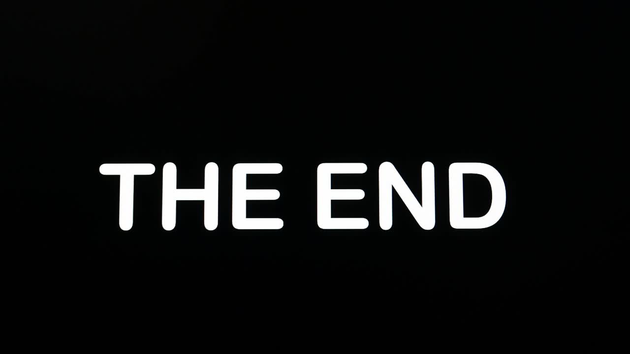 Encoding upper case letters for the words - The End on a computer screen with a deep-black background