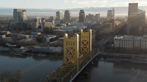 aerial drone tilt up of tower bridge and downtown sacramento, ca, including old sacramento - state capitol in background during sunrise