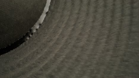 close-up of a dark grey material with a textured surface and a white border