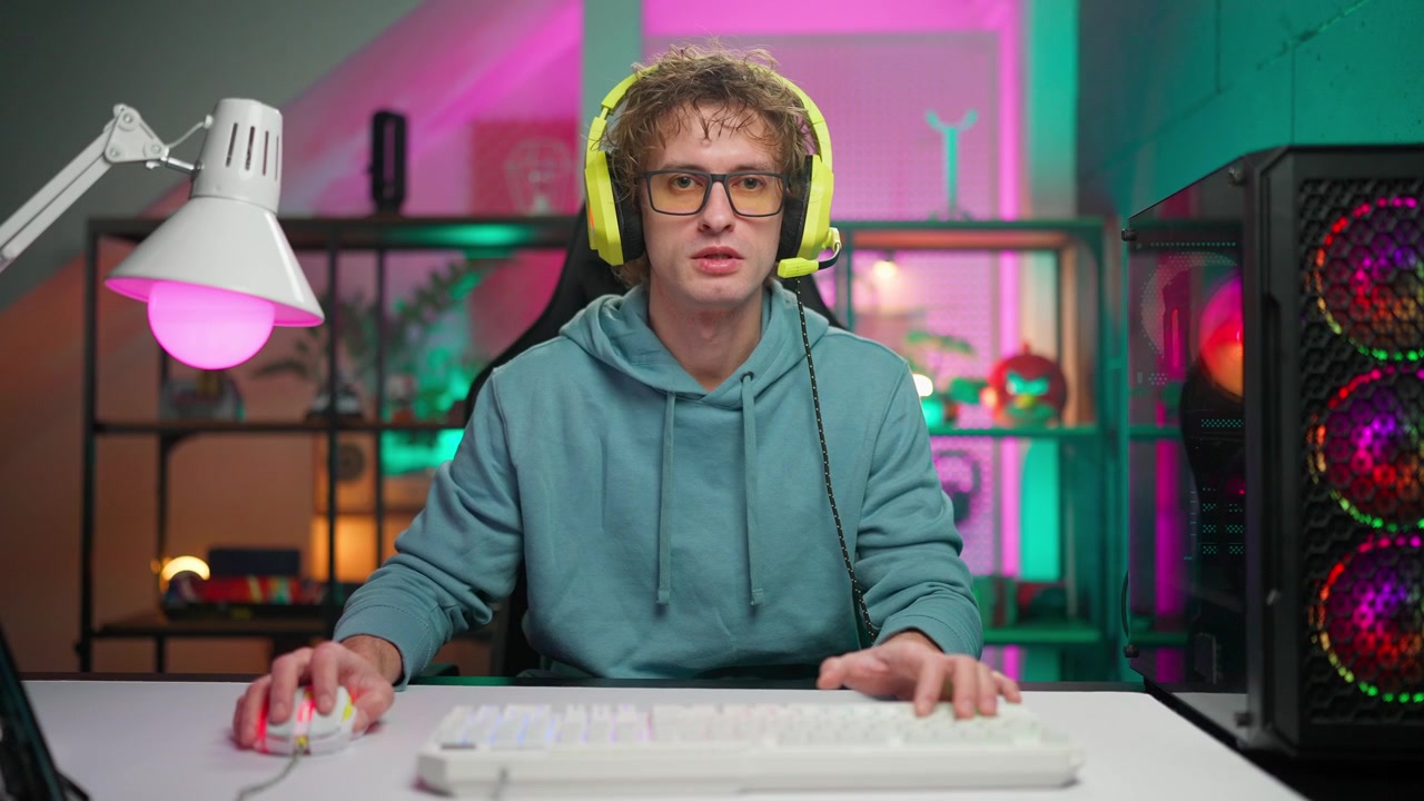 Junger Gamer mit Headset spricht in die Kamera