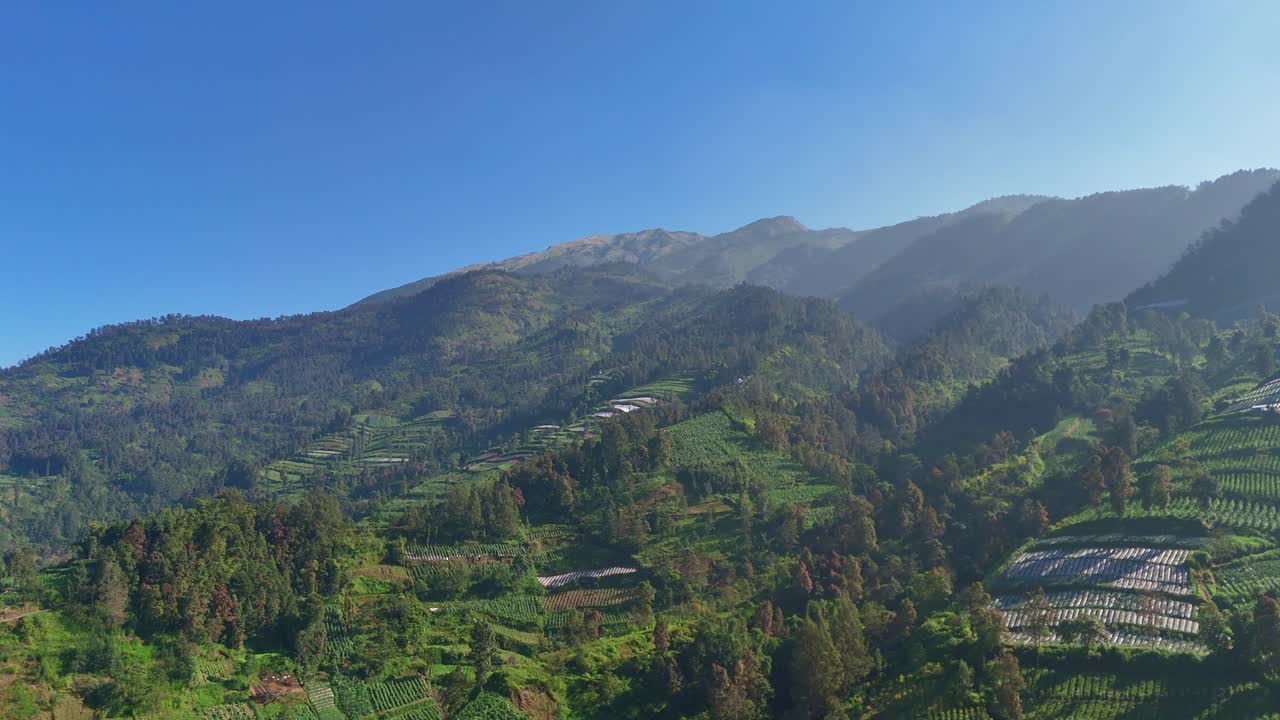 Aerial view of majestic greenery mountain scenery bathed in sunlight in sunny morning. Mount Merbabu, Indonesia