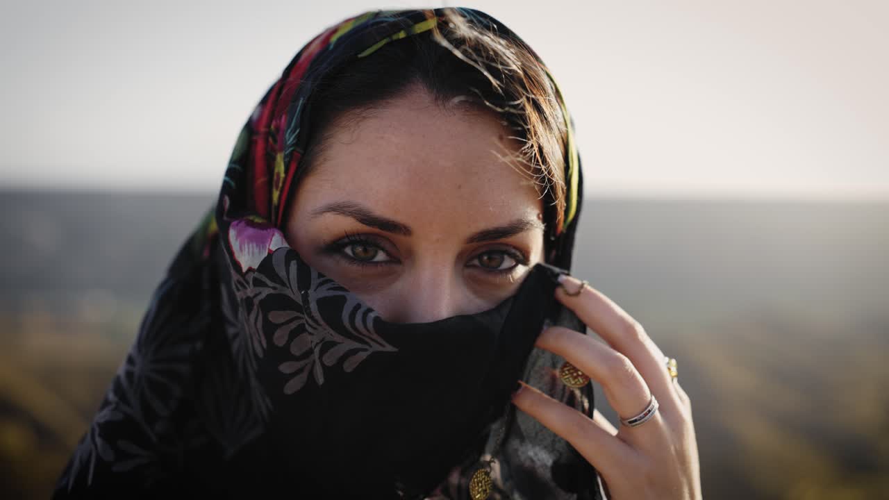 Mysterious middle eastern woman hiding face behind veil