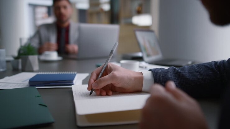Close-up view of entrepreneur holding a pen