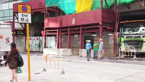 pedestrians pass by a construction site