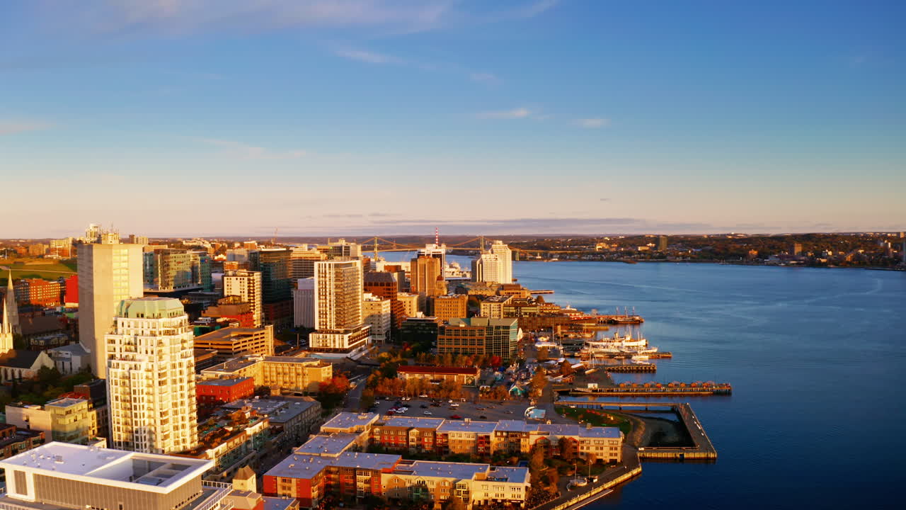 Sunrise aerial drone shot over Halifax downtown, Nova Scotia, Canada.
High view of the golden landscape and sea at down as the sun is rising in the early morning.