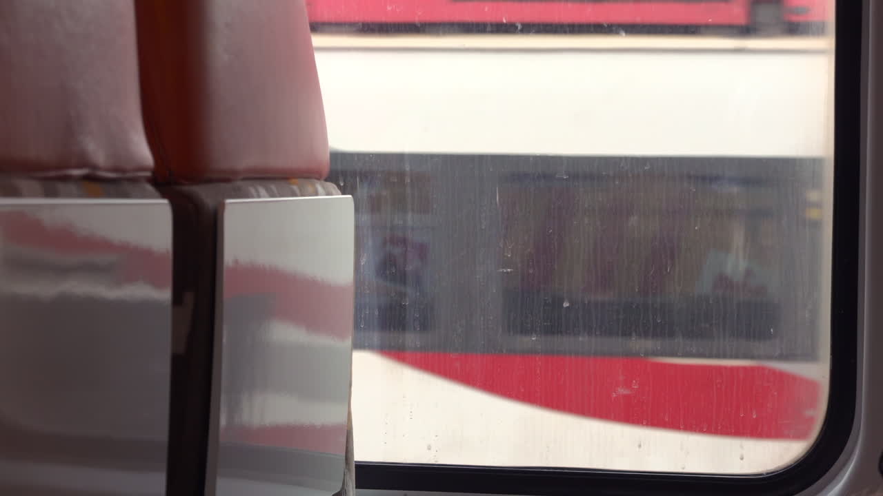 Villefranche sur Mer, France - March 24, 2025: View of the back of the window seats on a train passing by a station