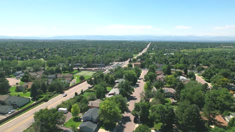 aerial drone flyover of cars driving in neighborhood of centennial, colorado, outside of denver colorado during the summertime