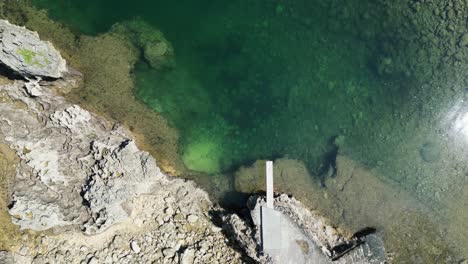 Twin-rock-resort-in-virac,-catanduanes-with-clear-waters-and-rocky-shore,-daylight,-aerial-view