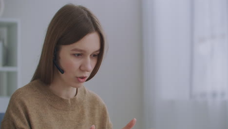 агент колл-центра носит гарнитуру видео звонки ноутбук. бизнес-женщина носит гарнитуру разговоры веб-камера делая дистанционный онлайн видеоконференц-звонок. интернет-учитель делает удаленный чат, работая из дома.