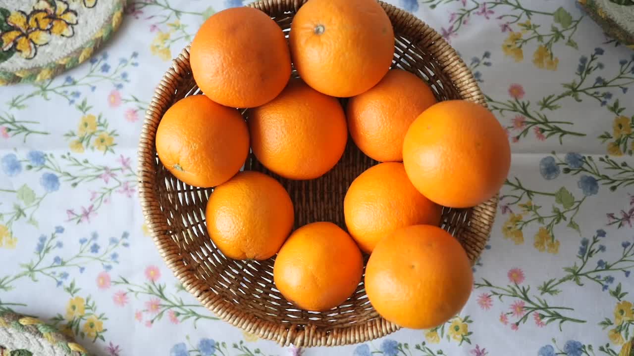 Oranges in a Basket on a Floral Tablecloth