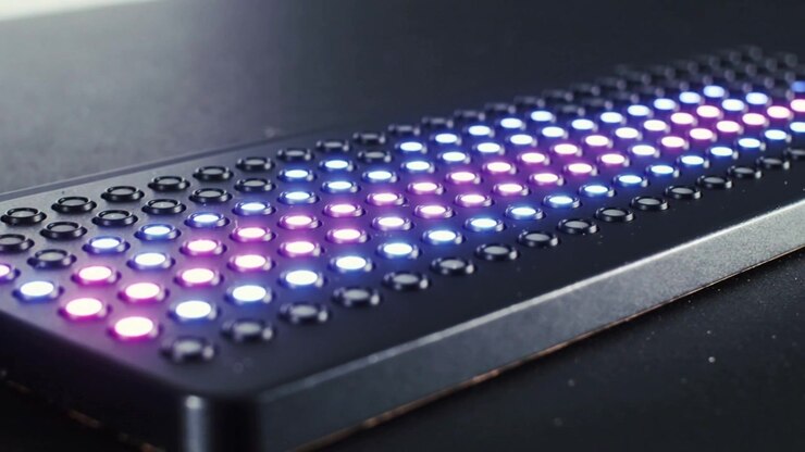Starting purple-blue LEDs expanding and sweeping right across black panel on tabletop, forming band